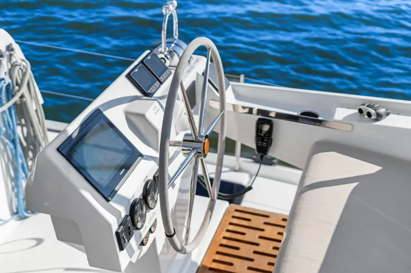 Halcyon Yacht Photos Pics 2024 Fountaine Pajot Aura 51 Catamaran helm with navigation instruments and ocean view.