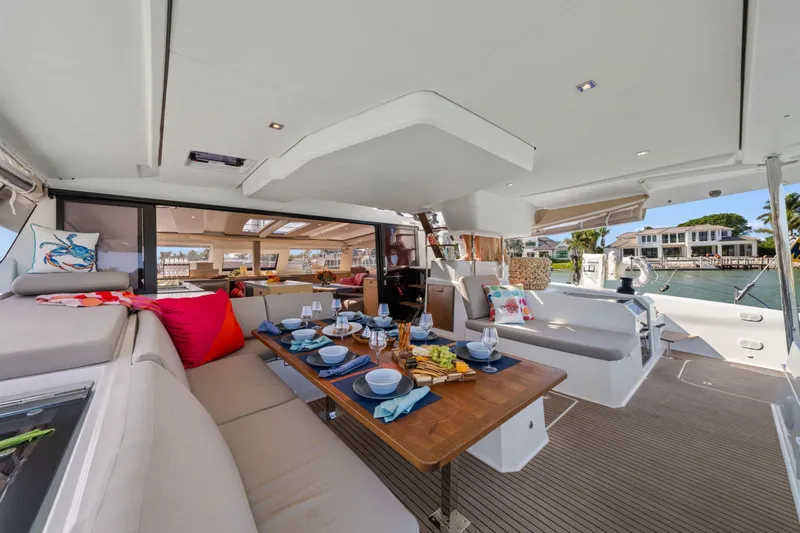 Halcyon Yacht Photos Pics Luxurious 2024 Fountaine Pajot Aura 51 Catamaran interior with elegant dining setup.