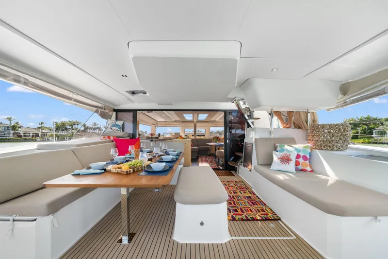 Halcyon Yacht Photos Pics 2024 Fountaine Pajot Aura 51 Catamaran interior with elegant dining setup and modern design.