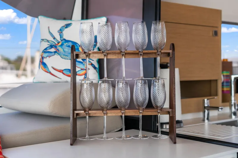 Halcyon Yacht Photos Pics Elegant glassware display on 2024 Fountaine Pajot Aura 51 Catamaran interior.