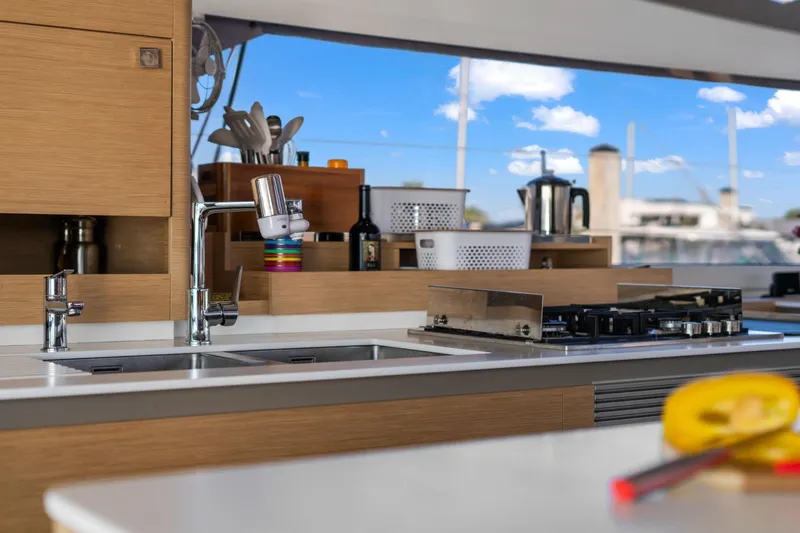 Halcyon Yacht Photos Pics Modern kitchen interior of 2024 Fountaine Pajot Aura 51 Catamaran with sleek design.