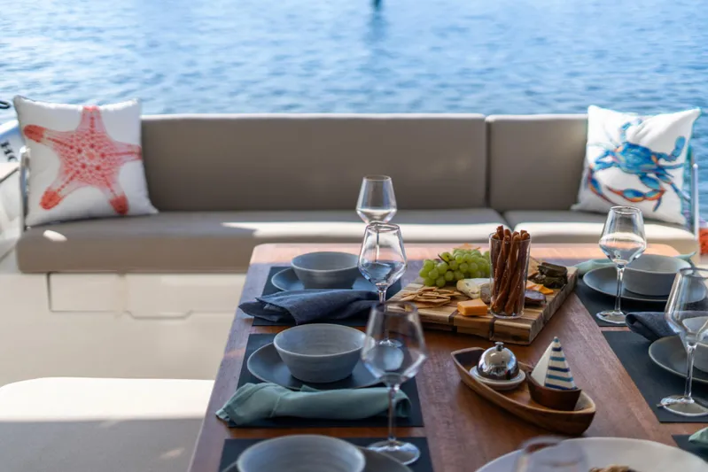 Halcyon Yacht Photos Pics Luxurious dining setup on 2024 Fountaine Pajot Aura 51 Catamaran with ocean view.