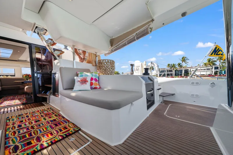 Halcyon Yacht Photos Pics 2024 Fountaine Pajot Aura 51 Catamaran interior with colorful decor and modern seating.
