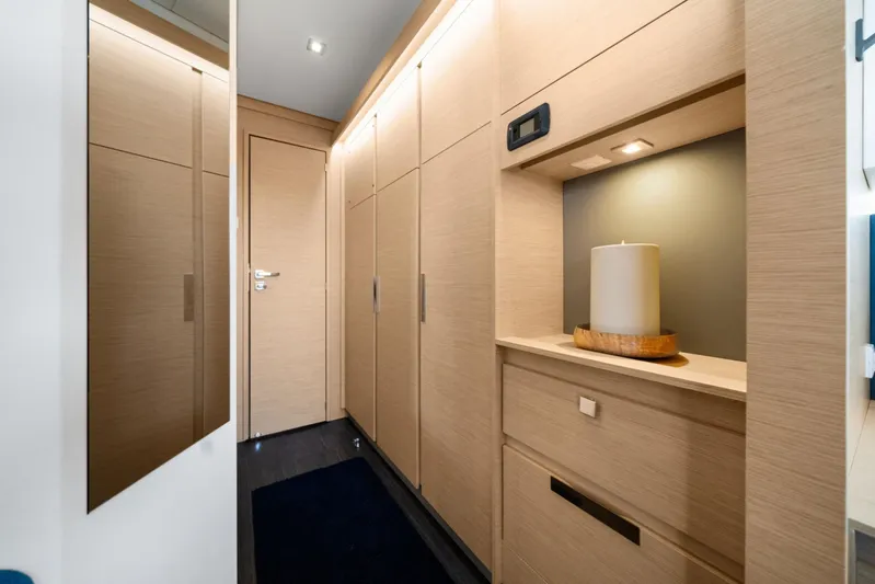 Halcyon Yacht Photos Pics 2024 Fountaine Pajot Aura 51 Catamaran interior with modern wood cabinetry and ambient lighting.