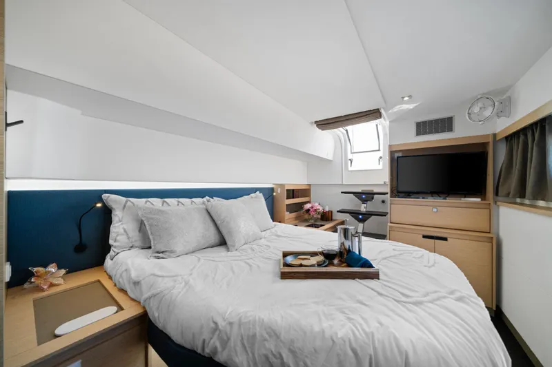 Halcyon Yacht Photos Pics Luxurious bedroom interior of 2024 Fountaine Pajot Aura 51 Catamaran with modern amenities.