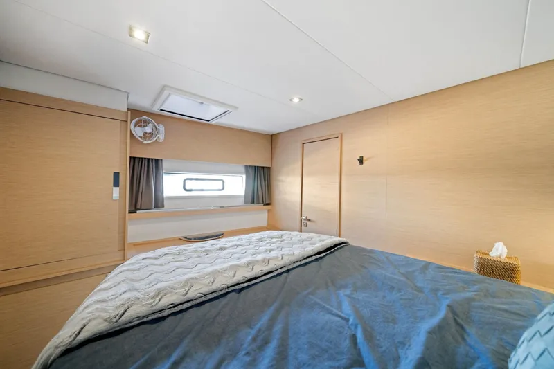Halcyon Yacht Photos Pics Interior cabin of 2024 Fountaine Pajot Aura 51 Catamaran, featuring modern design and cozy bedding.