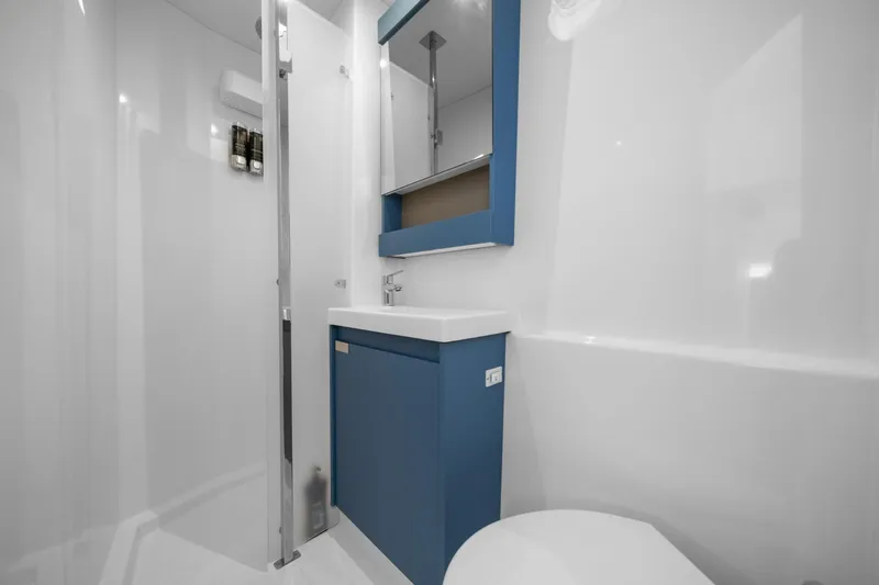 Halcyon Yacht Photos Pics Modern bathroom in 2024 Fountaine Pajot Aura 51 Catamaran with sleek design and blue accents.