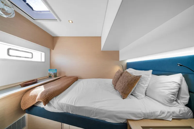 Halcyon Yacht Photos Pics Luxurious bedroom interior of 2024 Fountaine Pajot Aura 51 Catamaran with modern design.