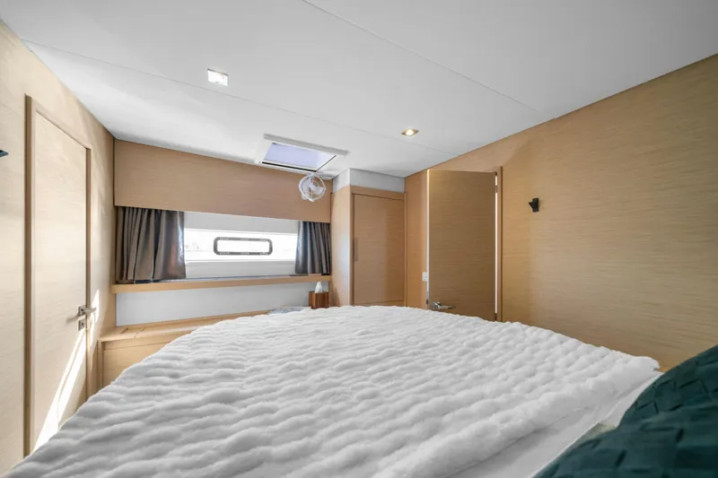 Halcyon Yacht Photos Pics Luxurious bedroom interior of 2024 Fountaine Pajot Aura 51 Catamaran with modern design.