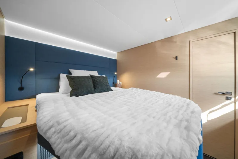 Halcyon Yacht Photos Pics Luxurious bedroom interior of 2024 Fountaine Pajot Aura 51 Catamaran with modern design.