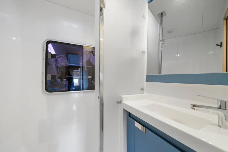 Halcyon Yacht Photos Pics Modern bathroom interior of 2024 Fountaine Pajot Aura 51 Catamaran, featuring sleek design and fixtures.