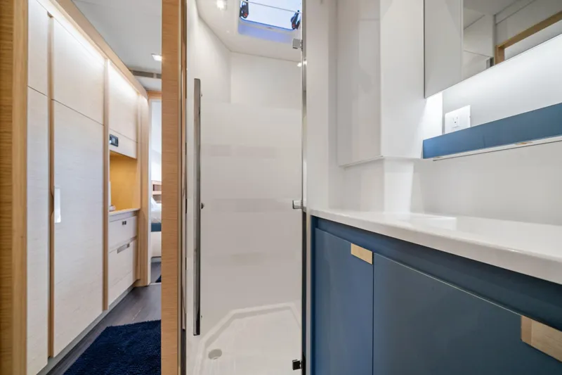 Halcyon Yacht Photos Pics 2024 Fountaine Pajot Aura 51 Catamaran interior, featuring modern bathroom and hallway design.