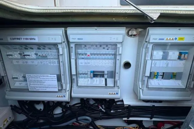 Halcyon Yacht Photos Pics Electrical panel of 2024 Fountaine Pajot Aura 51 Catamaran, showcasing circuit breakers and wiring.