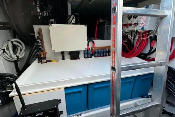 Halcyon Yacht Photos Pics 2024 Fountaine Pajot Aura 51 Catamaran engine room with electrical components and ladder.
