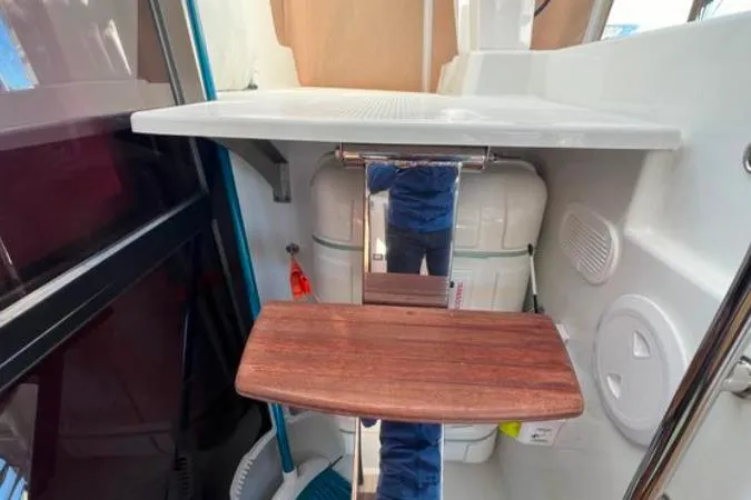 Halcyon Yacht Photos Pics 2024 Fountaine Pajot Aura 51 Catamaran interior with wooden step and storage area.