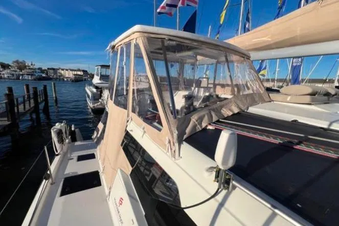 Halcyon Yacht Photos Pics 2024 Fountaine Pajot Aura 51 Catamaran docked, featuring a covered cockpit and sleek design.