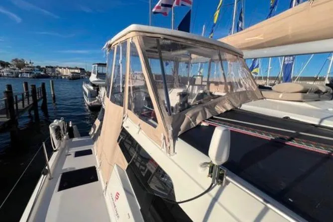 Halcyon Yacht Photos Pics 2024 Fountaine Pajot Aura 51 Catamaran docked, featuring a covered cockpit and sleek design.