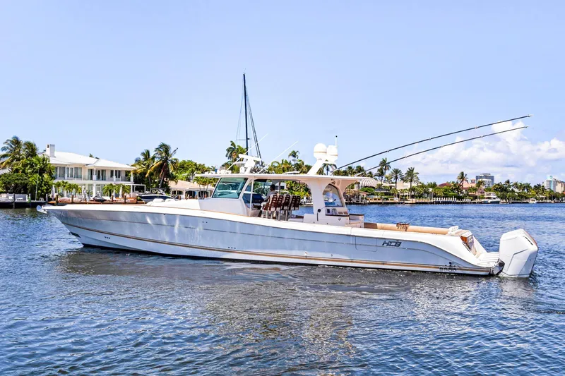 Book Ends Yacht Photos Pics Luxury 2021 HCB Estrella yacht cruising on a sunny day near waterfront homes.