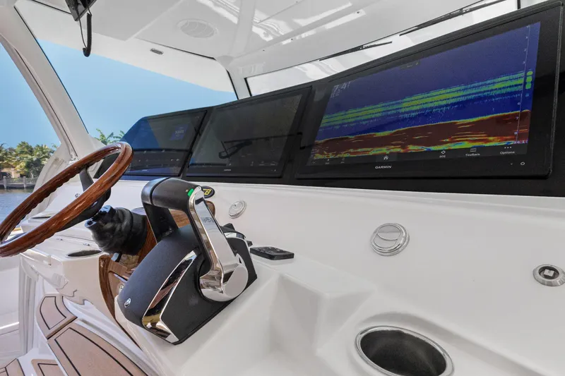 Book Ends Yacht Photos Pics 2021 HCB Estrella boat dashboard with advanced navigation screens and wooden steering wheel.