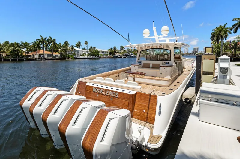 Book Ends Yacht Photos Pics 2021 HCB Estrella luxury yacht docked, featuring multiple outboard engines and elegant design.