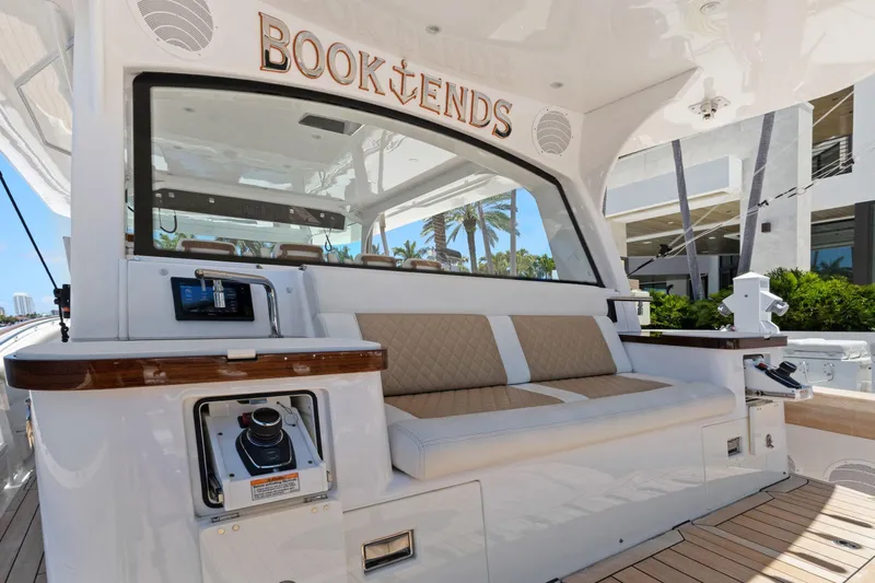 Book Ends Yacht Photos Pics 2021 HCB Estrella yacht interior with cushioned seating and control panel.