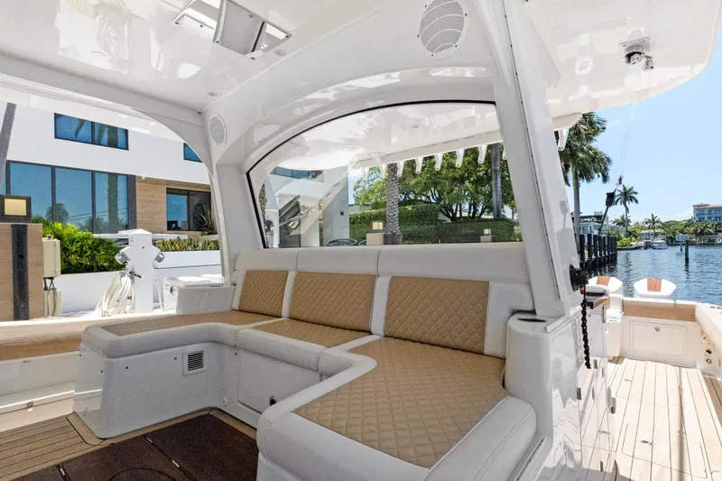 Book Ends Yacht Photos Pics Luxurious seating area on a 2021 HCB Estrella boat, docked by waterfront homes.