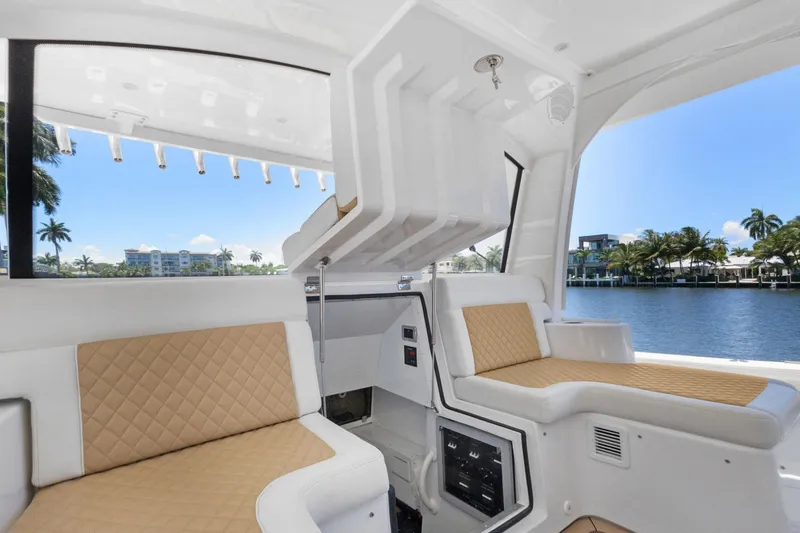 Book Ends Yacht Photos Pics Luxurious interior of 2021 HCB Estrella boat with beige seating and waterfront view.