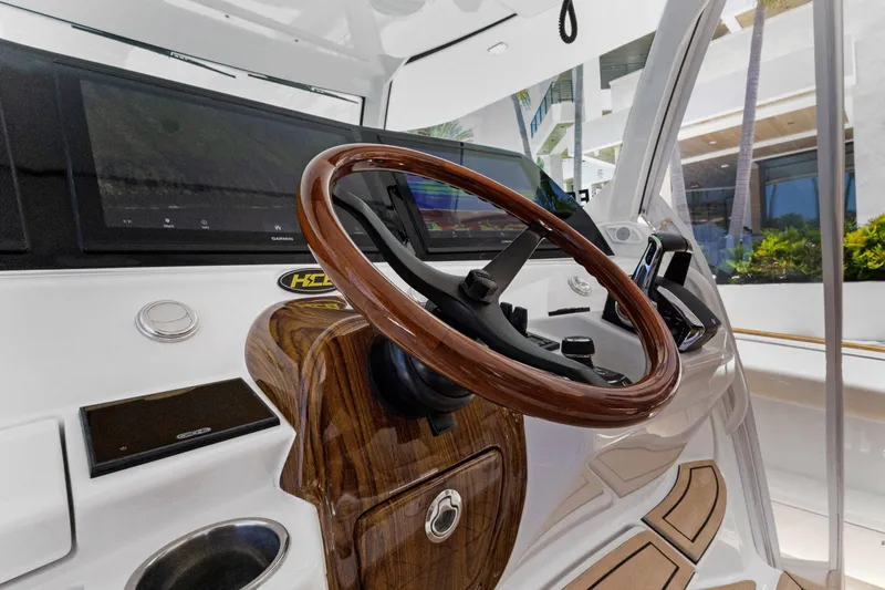 Book Ends Yacht Photos Pics Steering wheel of 2021 HCB Estrella boat with modern dashboard and controls.