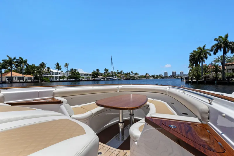 Book Ends Yacht Photos Pics Luxurious 2021 HCB Estrella yacht interior with elegant seating and table, overlooking scenic waterfront.