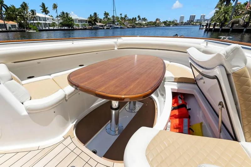 Book Ends Yacht Photos Pics Luxurious 2021 HCB Estrella boat interior with elegant seating and wooden table.