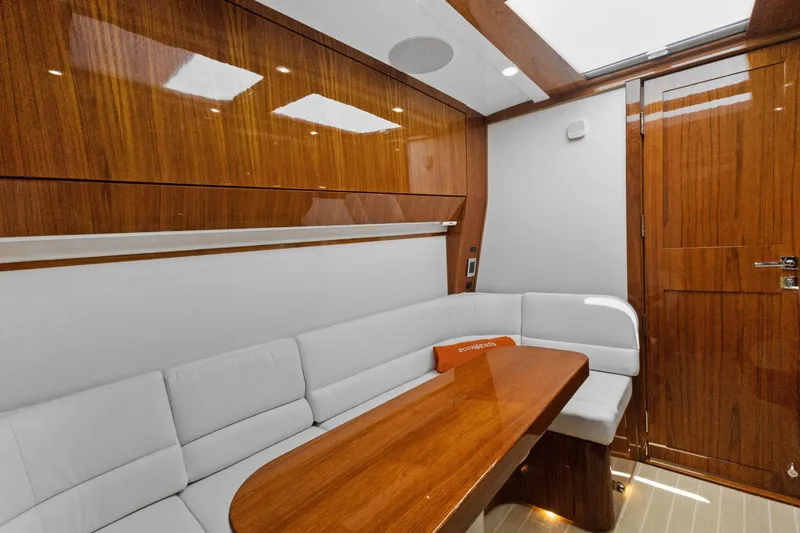 Book Ends Yacht Photos Pics Luxurious interior of 2021 HCB Estrella yacht with wooden finishes and white seating.