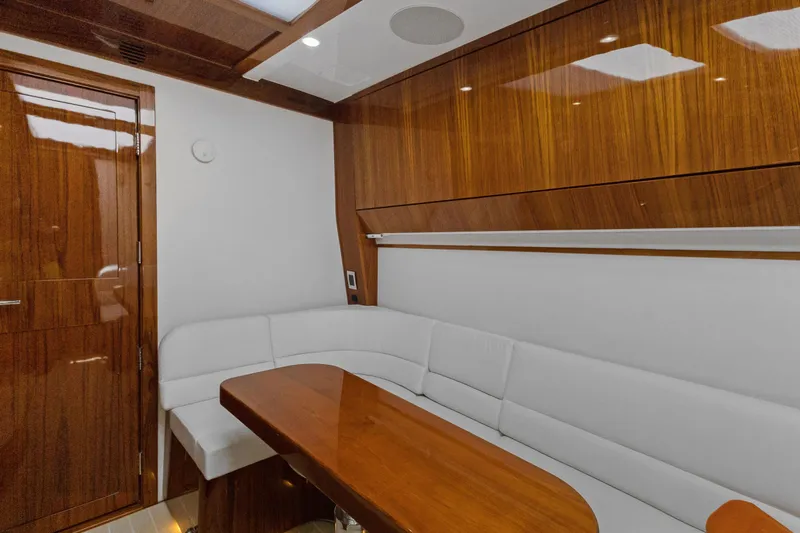 Book Ends Yacht Photos Pics Luxurious interior of 2021 HCB Estrella yacht with wooden finishes and white seating.