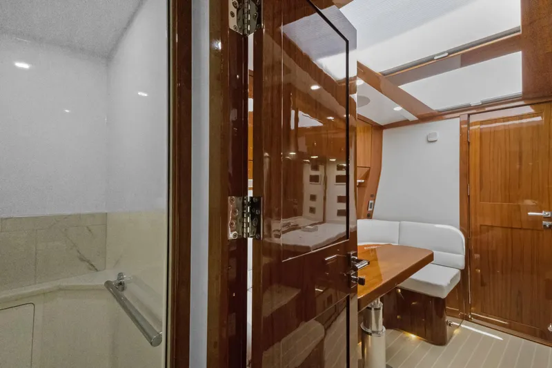 Book Ends Yacht Photos Pics Luxurious interior of 2021 HCB Estrella yacht with wooden finishes and seating area.