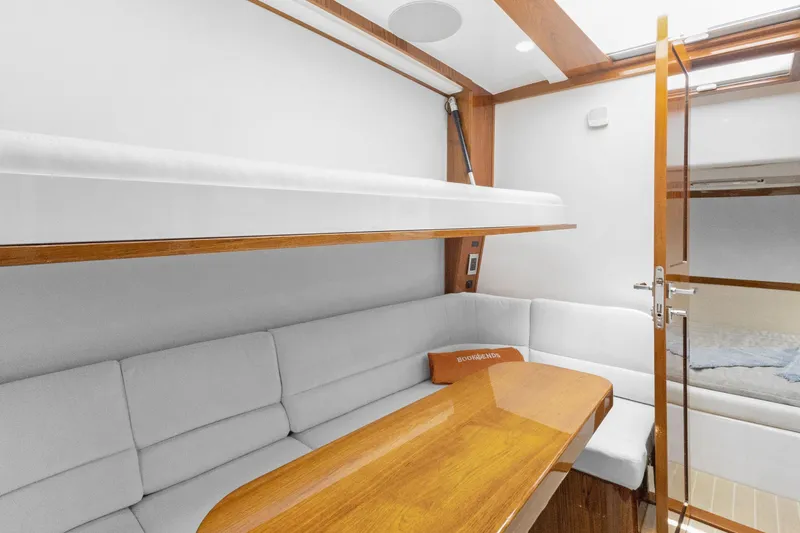 Book Ends Yacht Photos Pics Luxurious interior of 2021 HCB Estrella yacht with cozy seating and wooden accents.