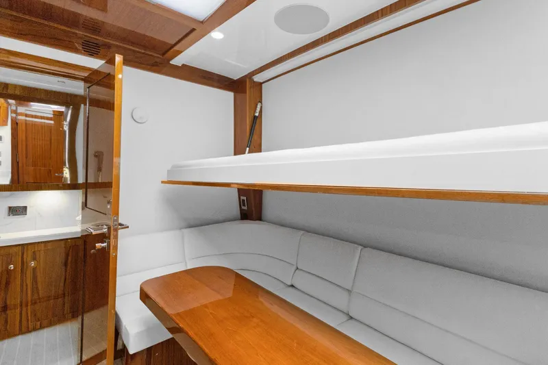Book Ends Yacht Photos Pics Luxurious interior of 2021 HCB Estrella yacht with elegant wood finishes and comfortable seating.