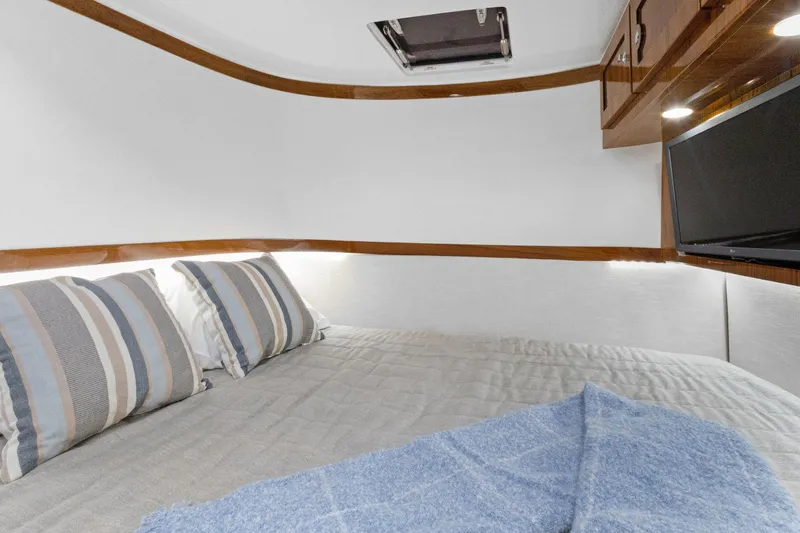 Book Ends Yacht Photos Pics Luxurious cabin interior of 2021 HCB Estrella yacht with cozy bedding and modern amenities.