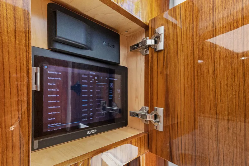 Book Ends Yacht Photos Pics Touchscreen control panel inside HCB Estrella 2021 yacht's wooden cabinet.