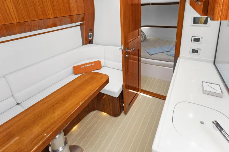 Book Ends Yacht Photos Pics Luxurious interior of 2021 HCB Estrella yacht with elegant wood finishes and cozy seating.