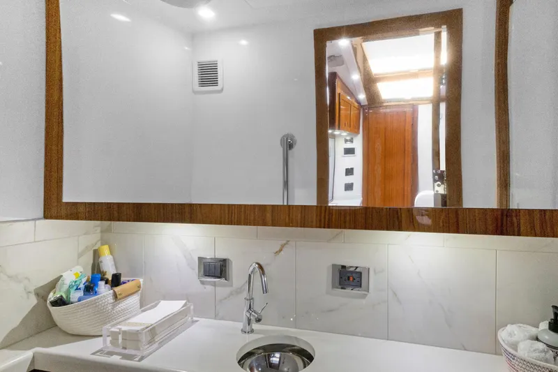 Book Ends Yacht Photos Pics Modern bathroom interior on 2021 HCB Estrella yacht, featuring sleek sink and mirror.