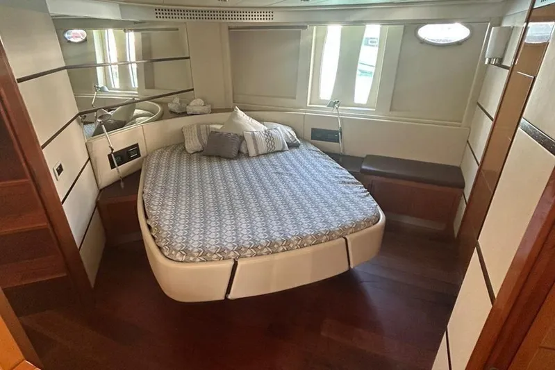  Yacht Photos Pics Luxurious bedroom interior of 2007 Pershing 62 yacht with elegant bedding and wood flooring.