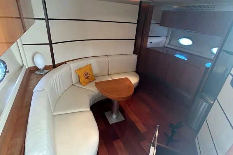  Yacht Photos Pics Luxurious interior of 2007 Pershing 62 yacht with white leather seating and wooden accents.