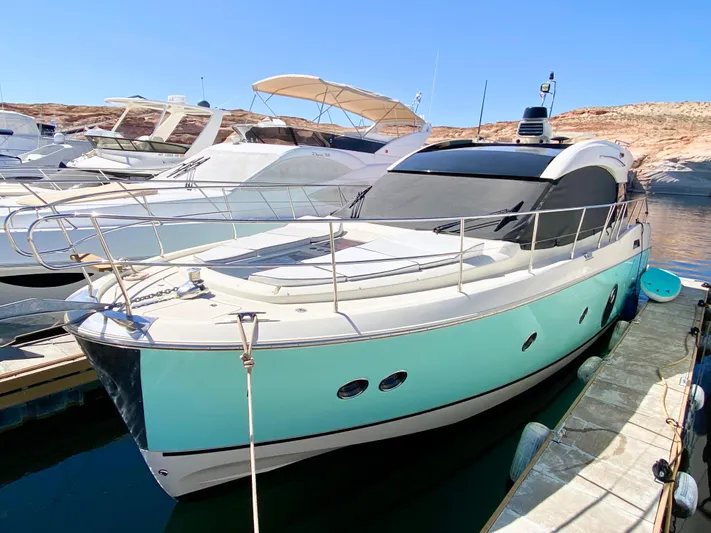 Revenant Yacht Photos Pics Monte Carlo MC5S 2015 yacht docked, featuring sleek design and turquoise hull.