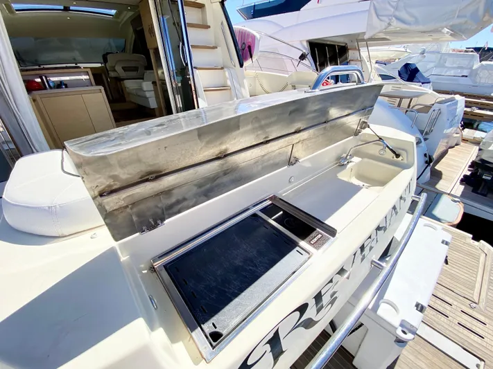 Revenant Yacht Photos Pics Outdoor kitchen on 2015 Monte Carlo MC5S yacht, featuring stainless steel grill and counter.