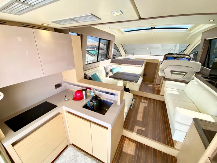 Revenant Yacht Photos Pics Luxurious interior of 2015 Monte Carlo MC5S yacht with modern kitchen and seating area.