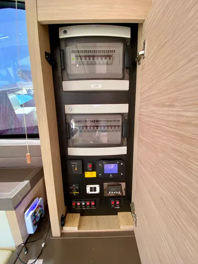 Revenant Yacht Photos Pics Electrical panel inside 2015 Monte Carlo MC5S yacht, featuring control switches and circuit breakers.