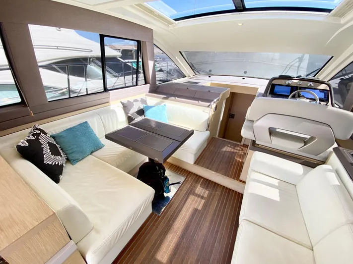 Revenant Yacht Photos Pics Luxurious interior of 2015 Monte Carlo MC5S yacht with elegant seating and modern design.