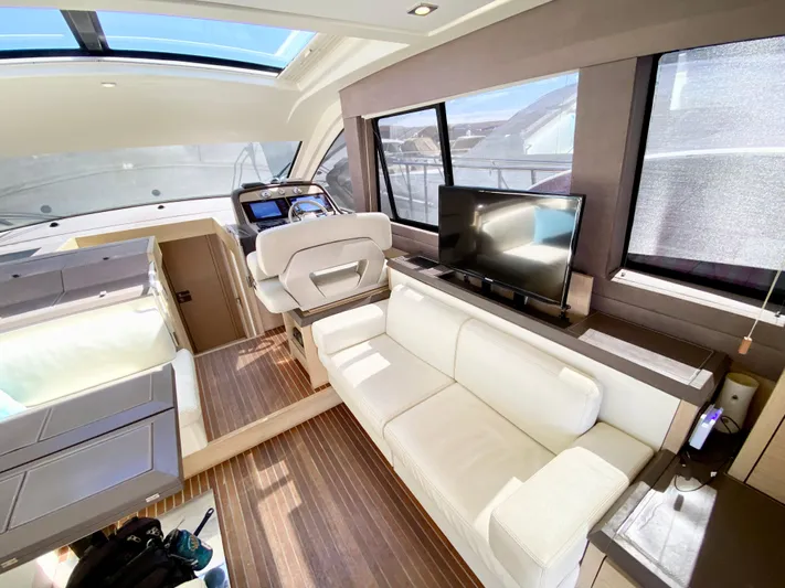 Revenant Yacht Photos Pics Luxurious interior of 2015 Monte Carlo MC5S yacht with white seating and modern amenities.