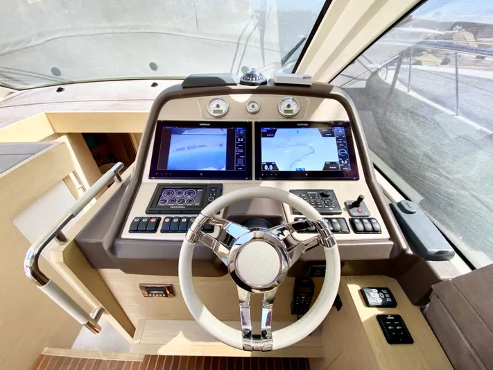 Revenant Yacht Photos Pics 2015 Monte Carlo MC5S yacht helm with dual navigation screens and modern controls.