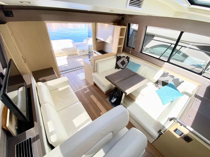 Revenant Yacht Photos Pics Luxurious interior of 2015 Monte Carlo MC5S yacht with elegant seating and dining area.