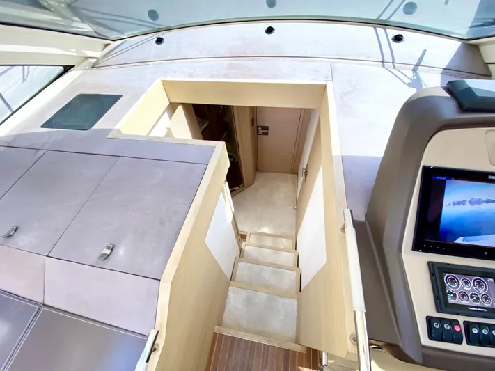 Revenant Yacht Photos Pics Interior view of 2015 Monte Carlo MC5S yacht, featuring stairs and control panel.